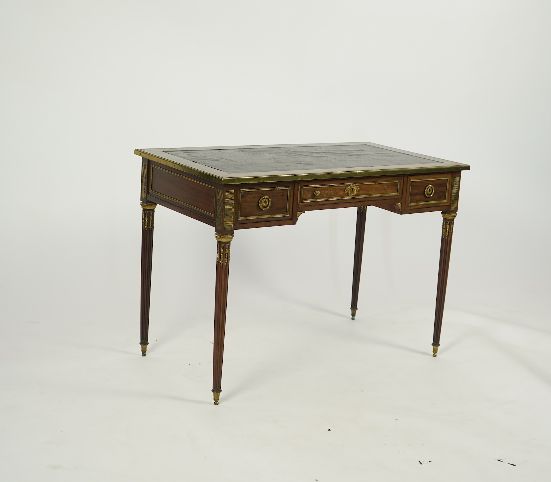 An early 20th century Louis XVI style brass mounted mahogany writing table